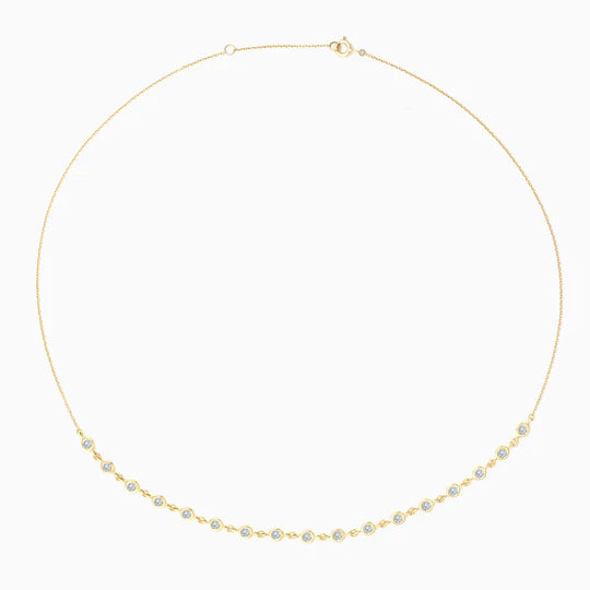This half-set tennis necklace boasts stunning bezel set stones, elevating any outfit with its elegant touch. Shop now at FalenaFineJewelry.com or in-store